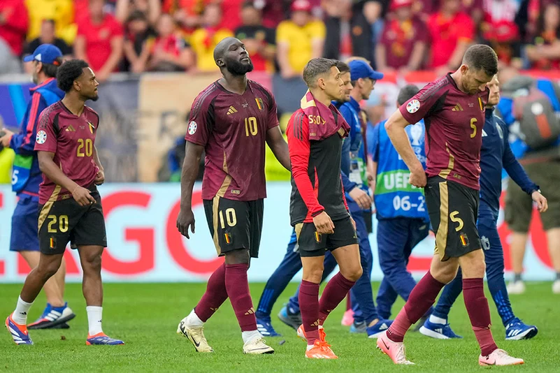 Belgium players leave the pitch after they lost to France